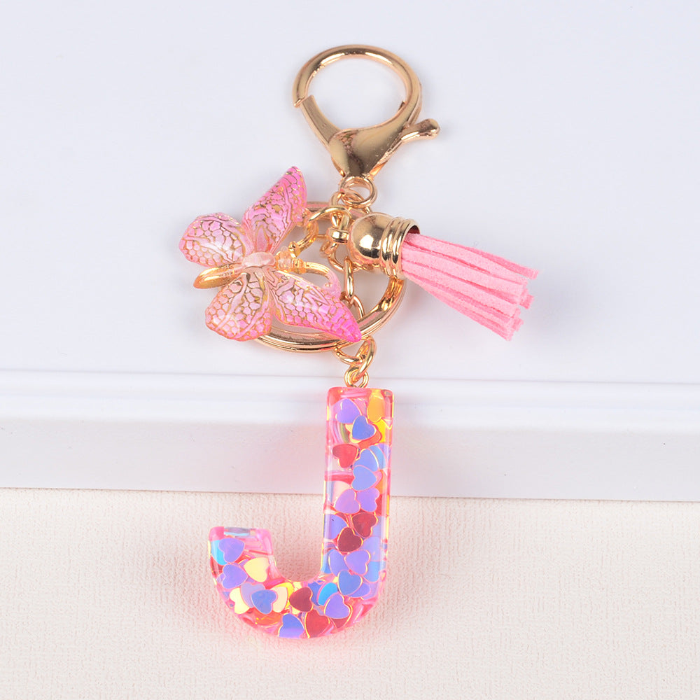 卸売ピンクタッセルバタフライグリッターレター樹脂キーホルダー