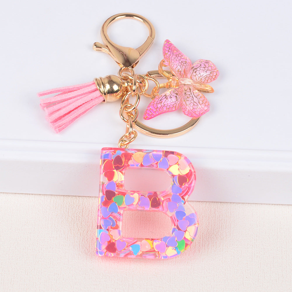 卸売ピンクタッセルバタフライグリッターレター樹脂キーホルダー