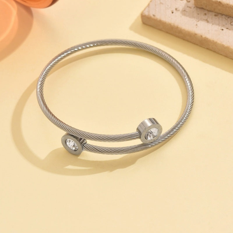 Wholesale Stainless steel artificial zircon silver open bangle with a twisted design