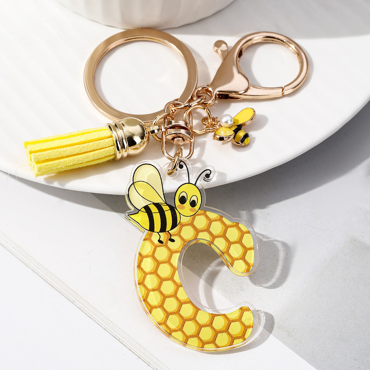 Wholesale Bee Honeycomb Acrylic English Letter Tassel Bee Enamel Keychain
