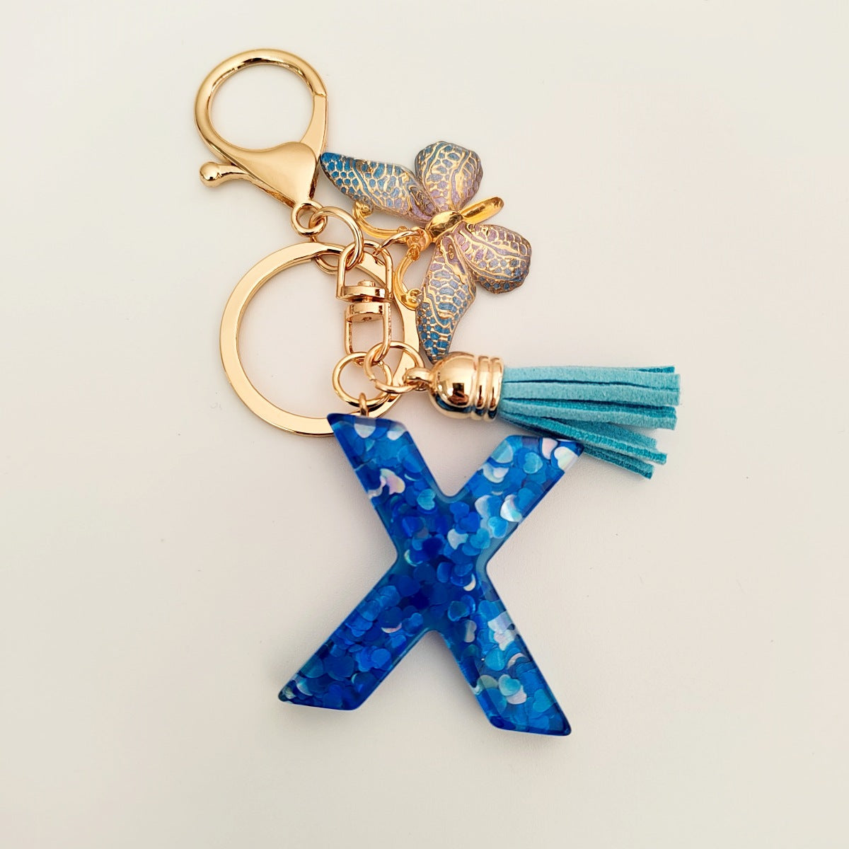 Wholesale blue crystal epoxy letter key chain pendant resin sequined butterfly key chain