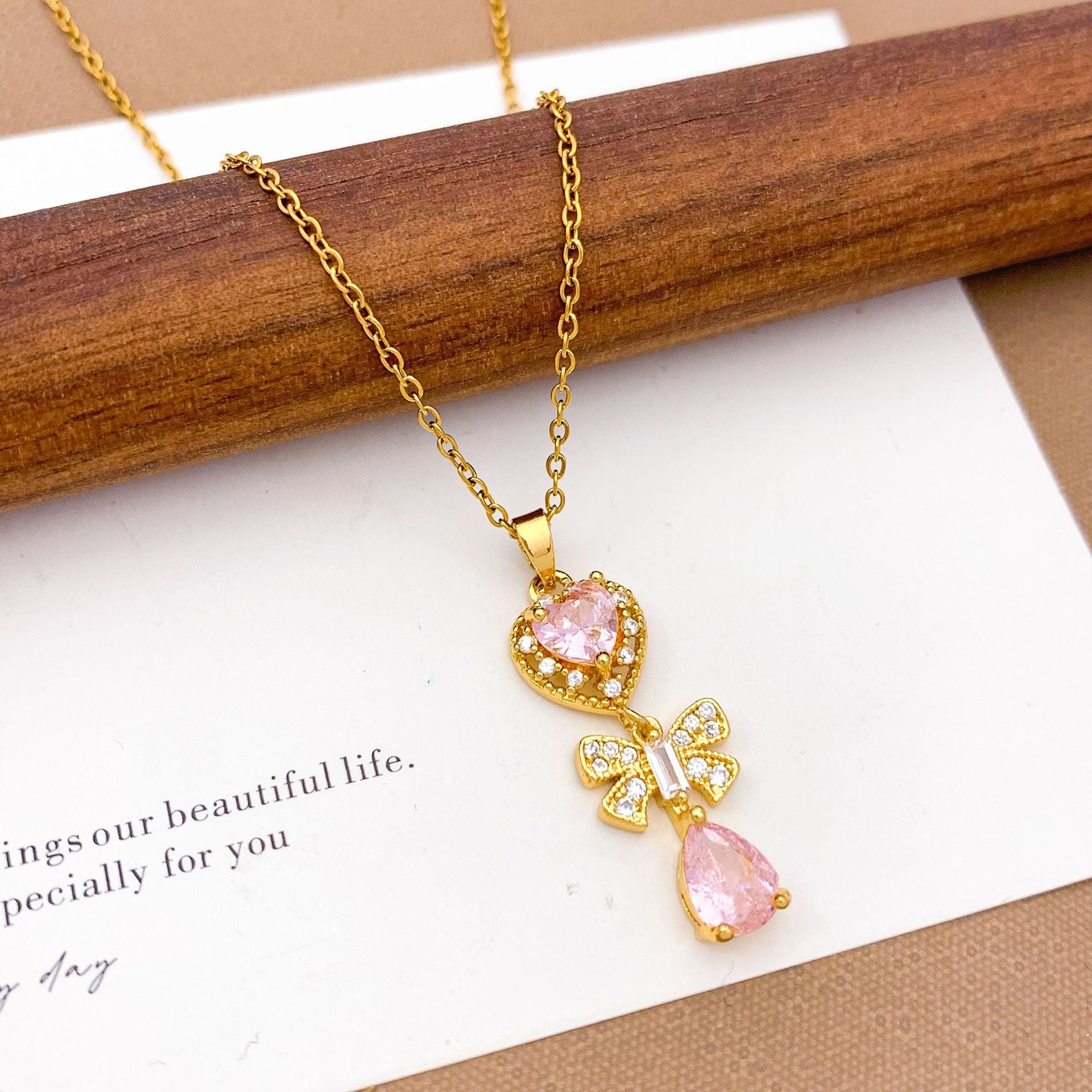 Wholesale Pink heart-shaped bow with diamond studded titanium steel necklace