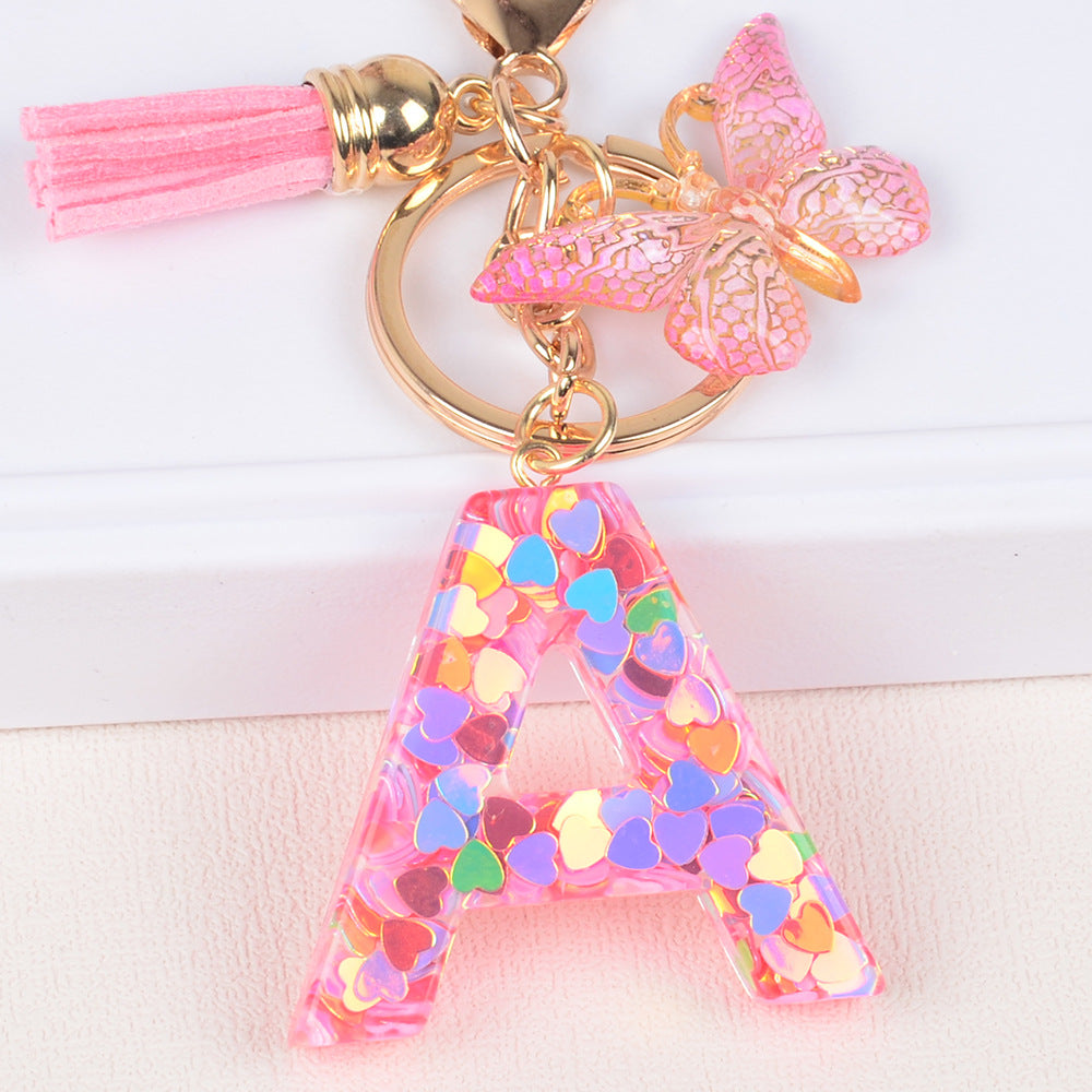 卸売ピンクタッセルバタフライグリッターレター樹脂キーホルダー