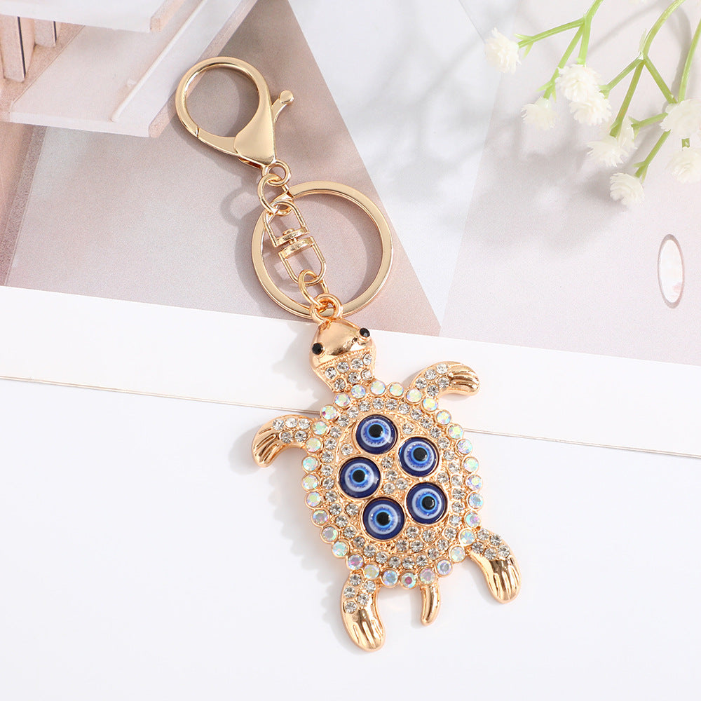 Wholesale Turtle shell with devil' s eye inlaid with rhinestones Metal Keychain