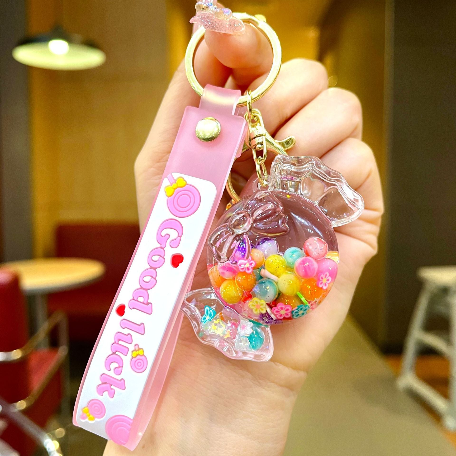 Wholesale Oil filled luminous colorful candy quicksand bottle keychain
