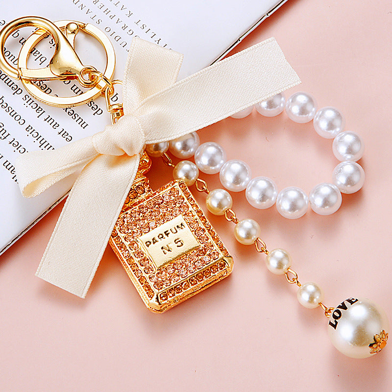 Wholesale Pearl Perfume Bottle Bow Rhinestone Keychain Bag Charm Chic Fashion Accessory Boutique Gift
