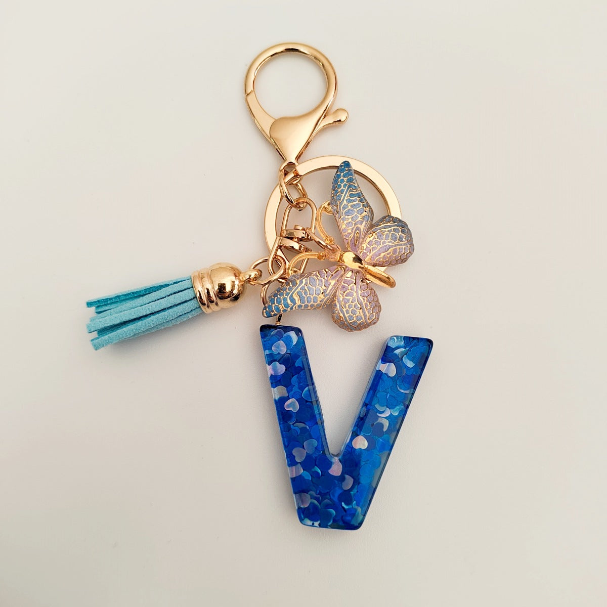 Wholesale blue crystal epoxy letter key chain pendant resin sequined butterfly key chain