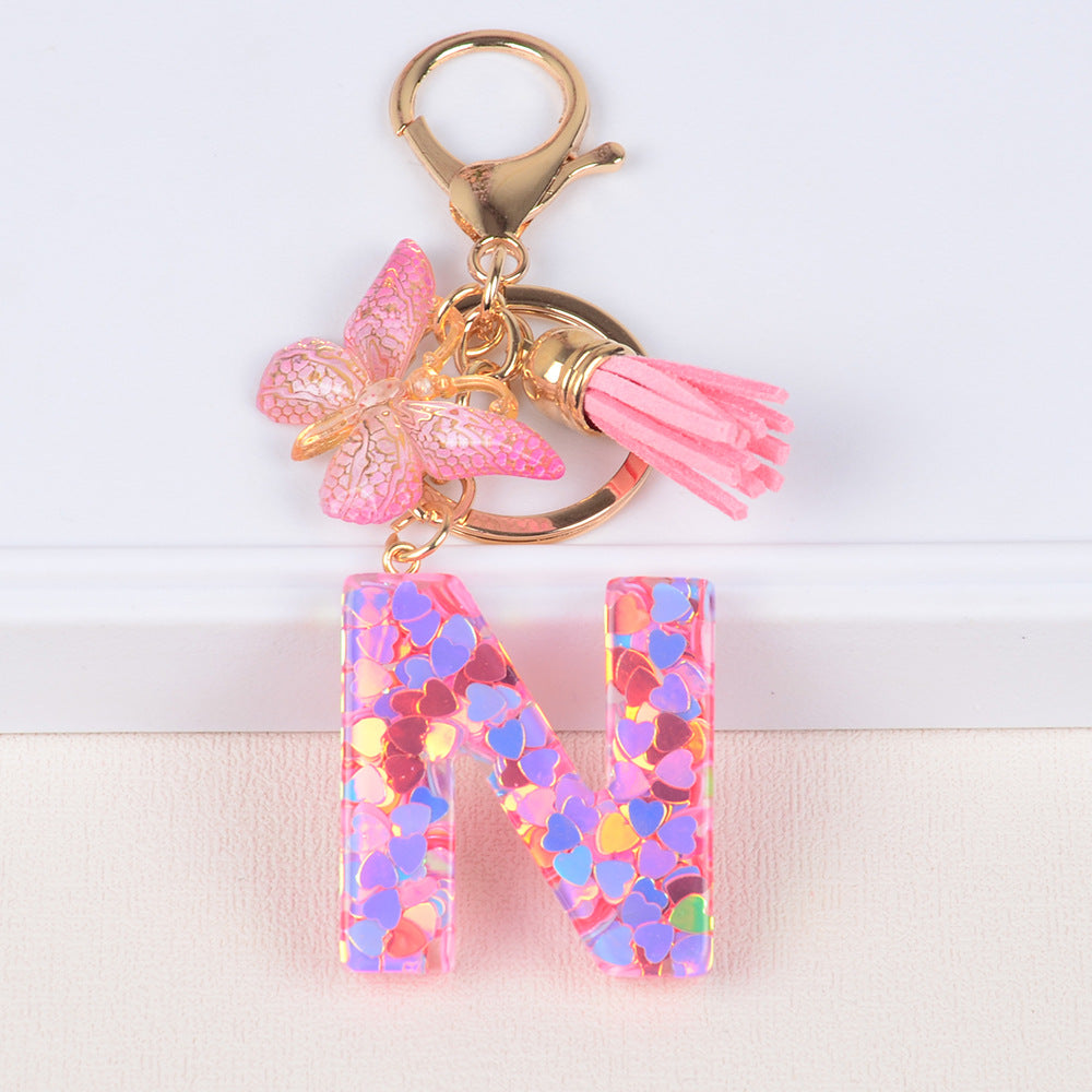 卸売ピンクタッセルバタフライグリッターレター樹脂キーホルダー