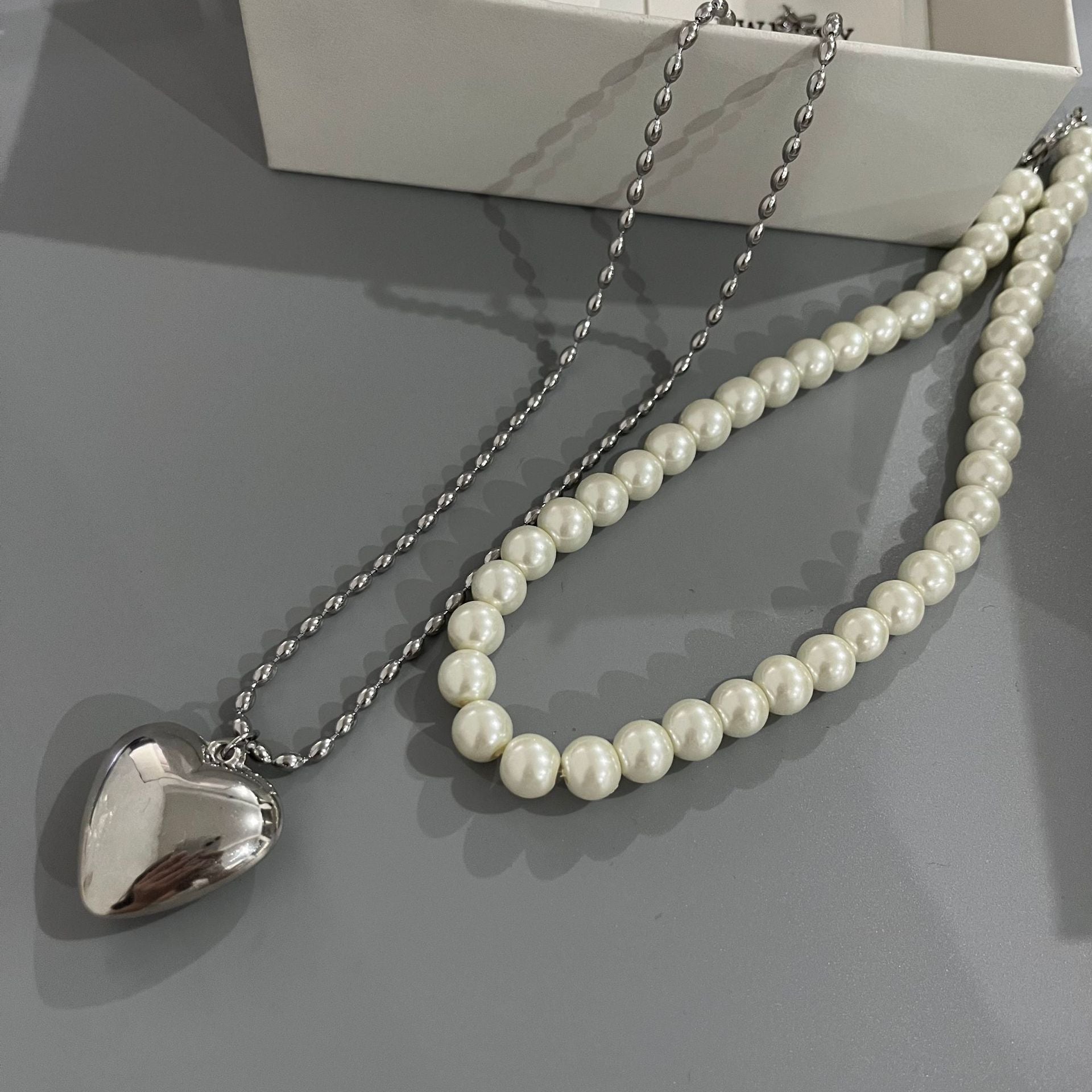 Wholesale Rice Bead Titanium Steel Necklace Hollow Heart Pendant Sweater Chain