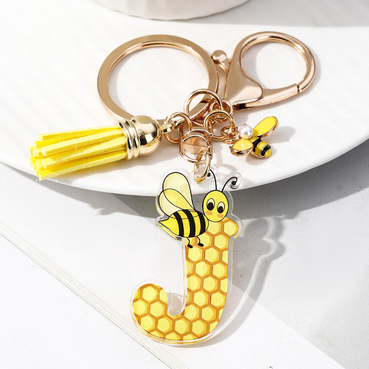 Wholesale Bee Honeycomb Acrylic English Letter Tassel Bee Enamel Keychain