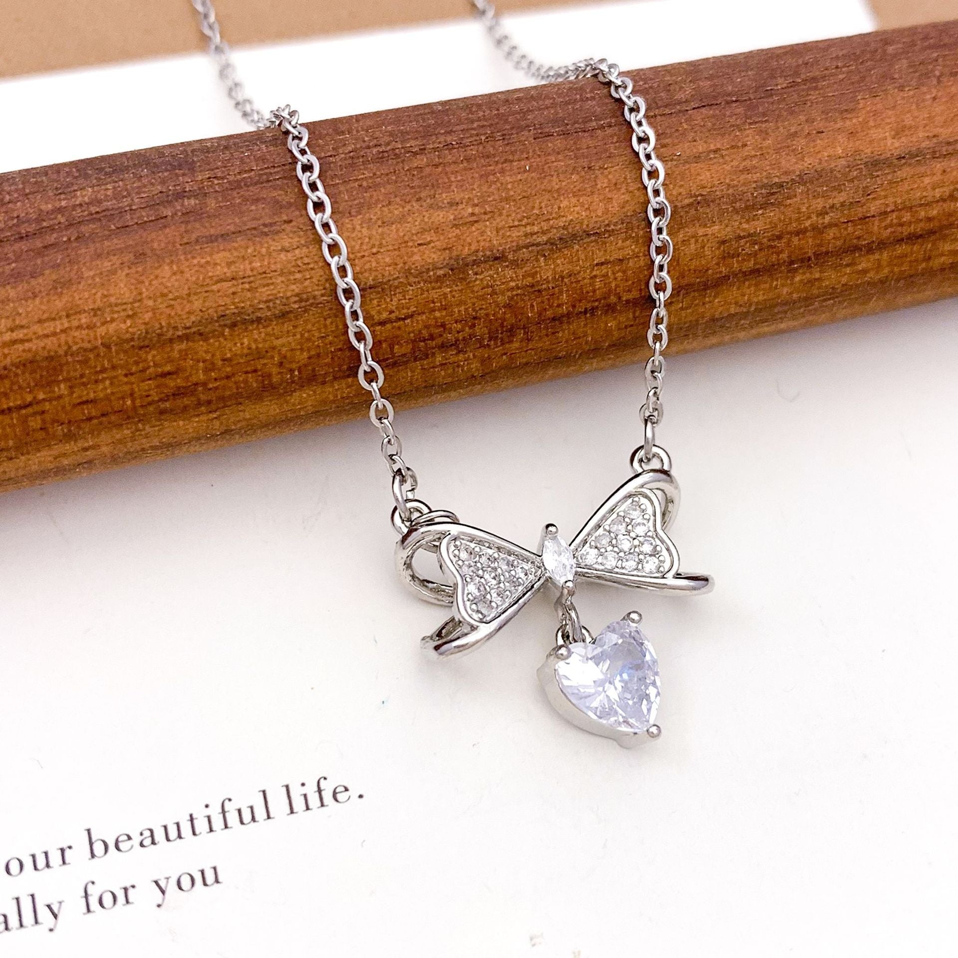 Wholesale Pink heart-shaped bow with diamond studded titanium steel necklace