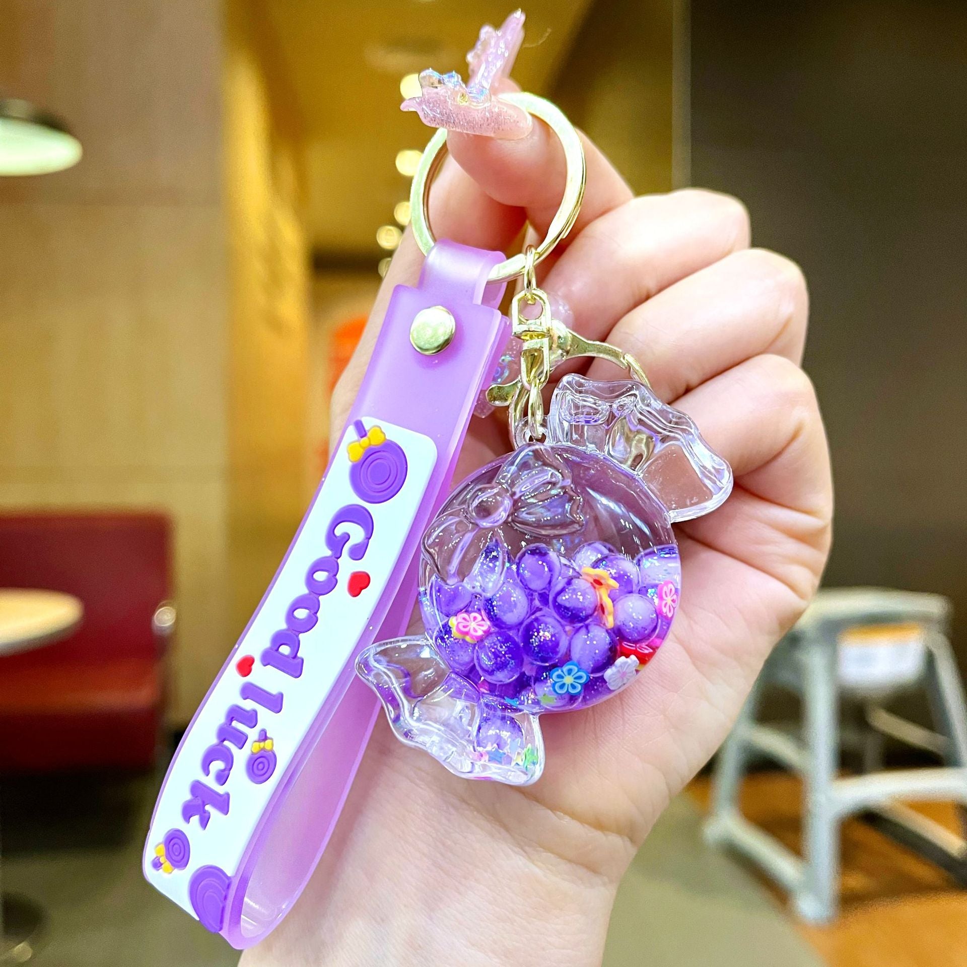 Wholesale Oil filled luminous colorful candy quicksand bottle keychain