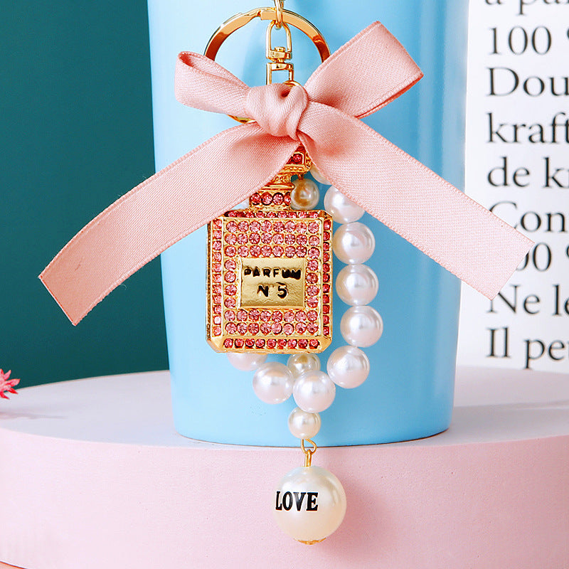 Wholesale Pearl Perfume Bottle Bow Rhinestone Keychain Bag Charm Chic Fashion Accessory Boutique Gift