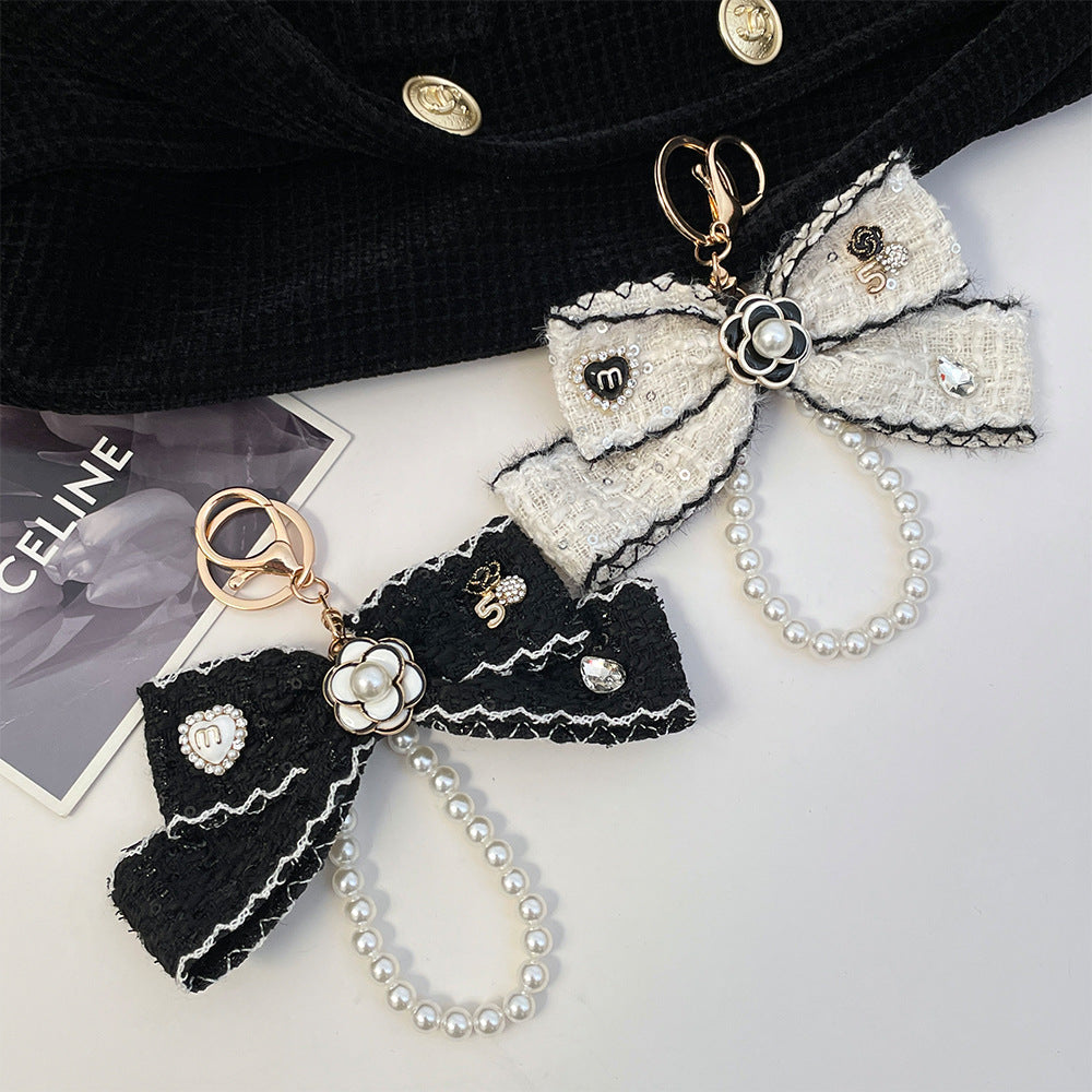 Wholesale Black and white color  style camellia pearl chain bow keychain