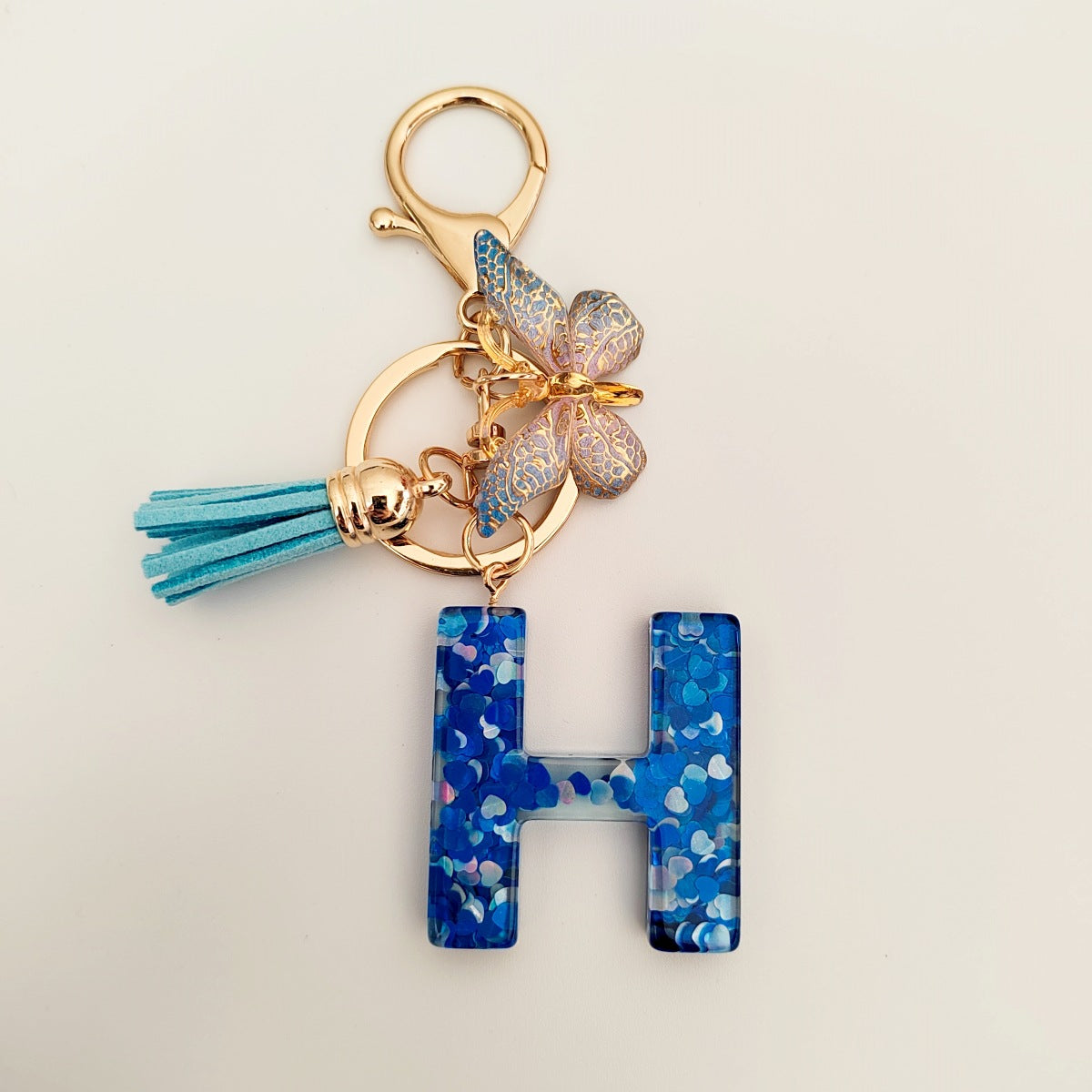 Wholesale blue crystal epoxy letter key chain pendant resin sequined butterfly key chain