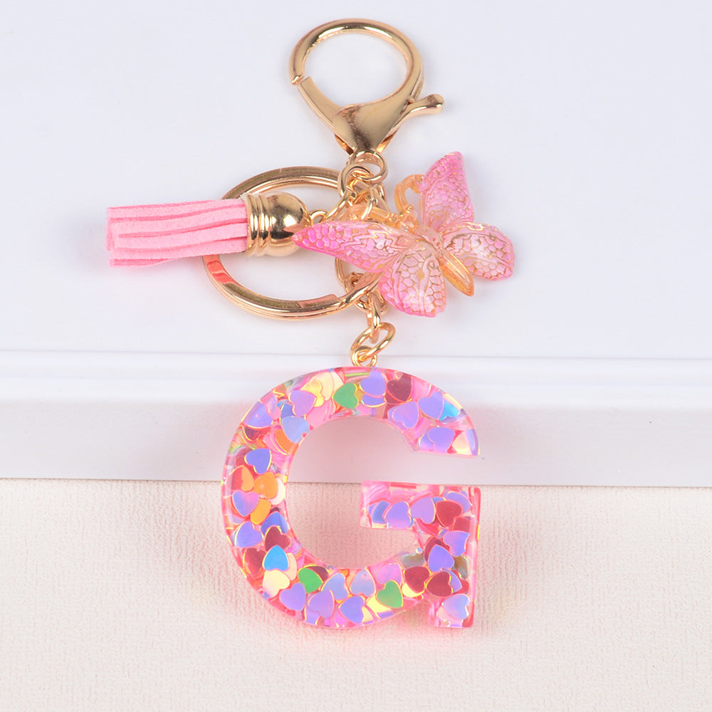 卸売ピンクタッセルバタフライグリッターレター樹脂キーホルダー