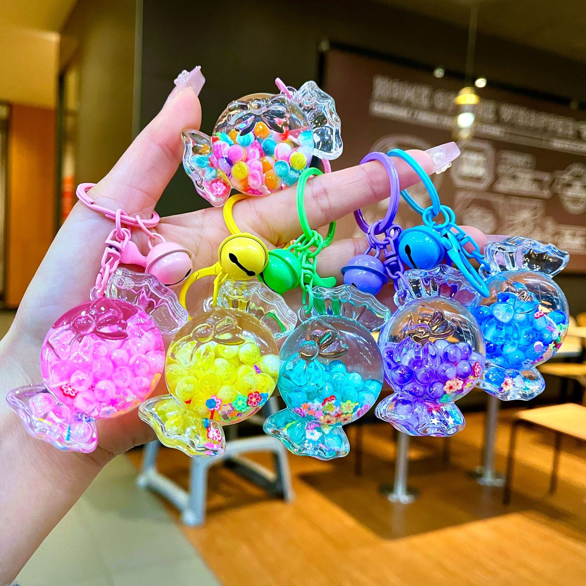 Wholesale Oil filled luminous colorful candy quicksand bottle keychain
