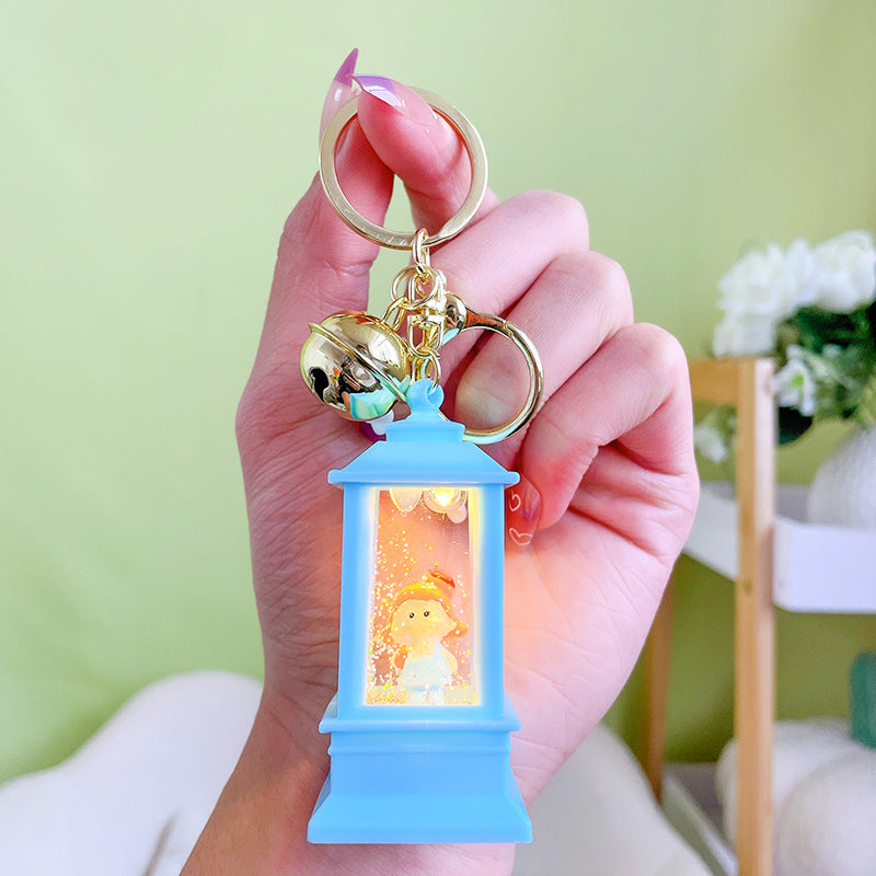 Llavero de faro acrílico al por mayor con luces y aceite para niñas