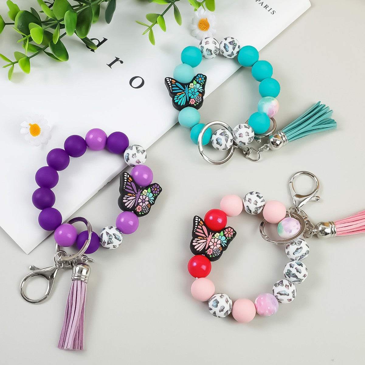 Wholesale Butterfly Pendant Beaded Wristlet Keychain Solid Color Silicone Wooden Keychain