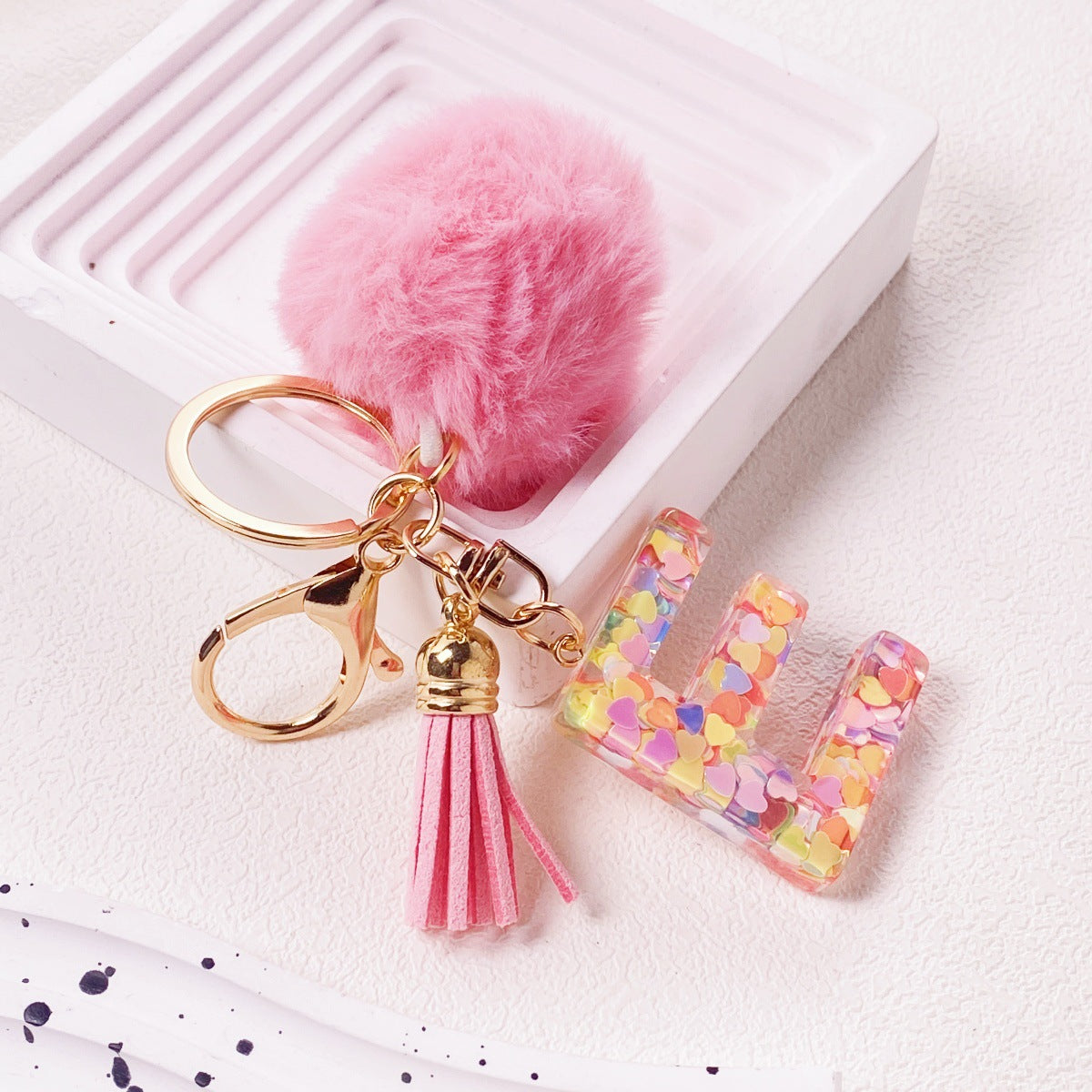 Wholesale Hairball English 26 letter pink Pom Pom keychain