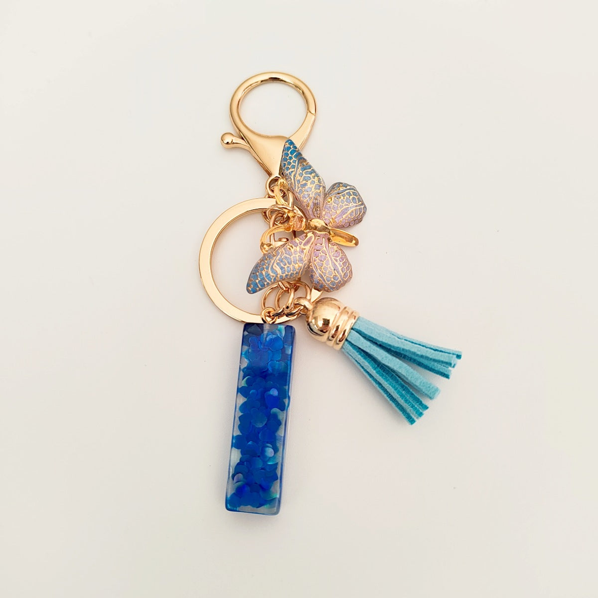 Wholesale blue crystal epoxy letter key chain pendant resin sequined butterfly key chain