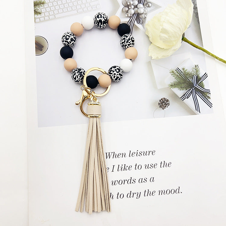 Wholesale Leopard Print White Bottom Wooden Beads Rubber Paint Round Beads PU Tassel Bracelet Keychain