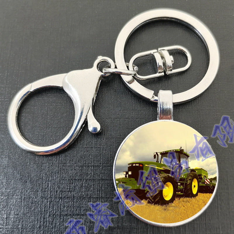 卸売タイムジェムトラクターラウンドガラスメタルキーホルダー