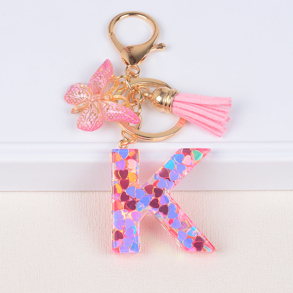 卸売ピンクタッセルバタフライグリッターレター樹脂キーホルダー
