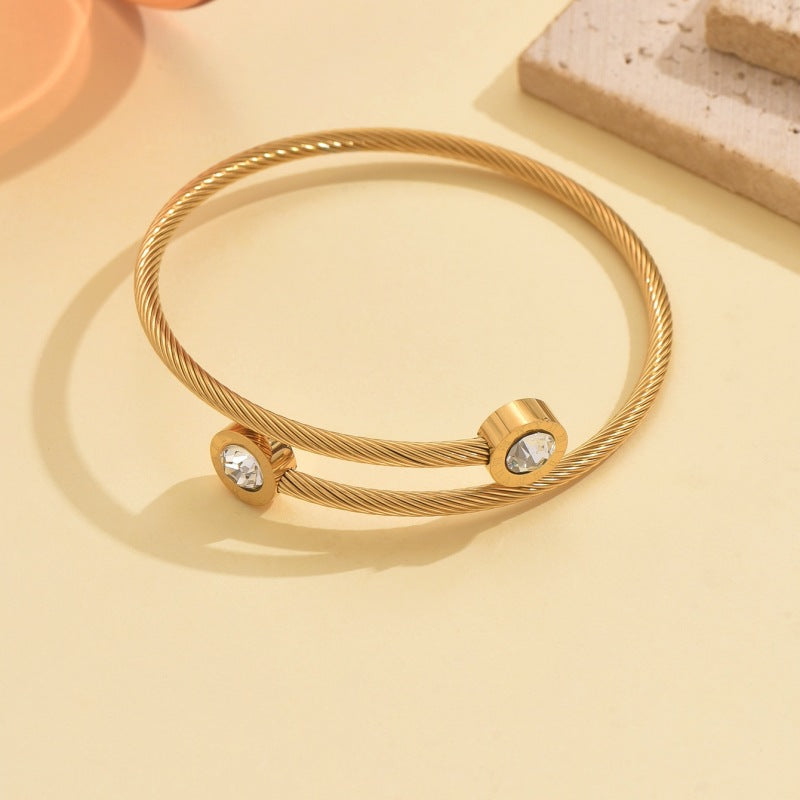 Wholesale Stainless steel artificial zircon silver open bangle with a twisted design