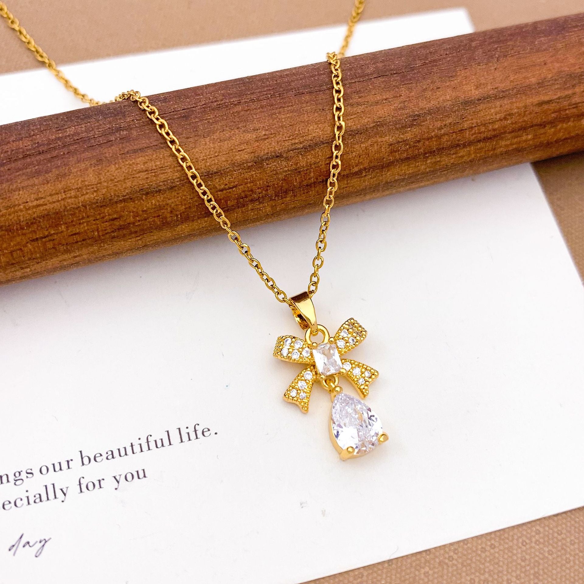 Wholesale Pink heart-shaped bow with diamond studded titanium steel necklace