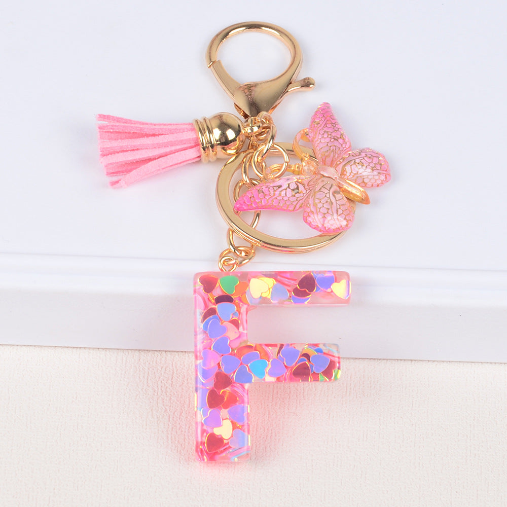 卸売ピンクタッセルバタフライグリッターレター樹脂キーホルダー