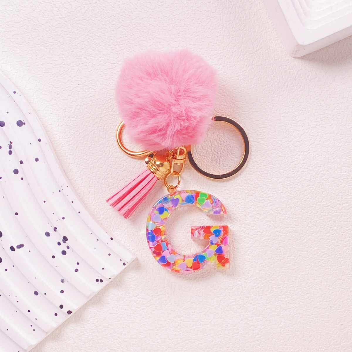 Wholesale Hairball English 26 letter pink Pom Pom keychain
