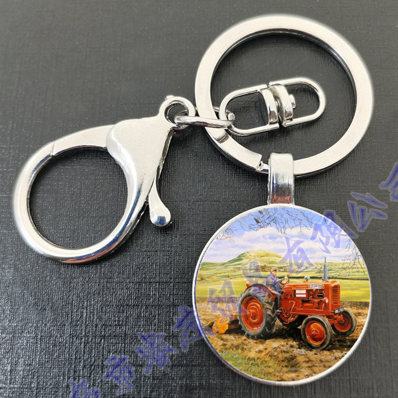 卸売タイムジェムトラクターラウンドガラスメタルキーホルダー