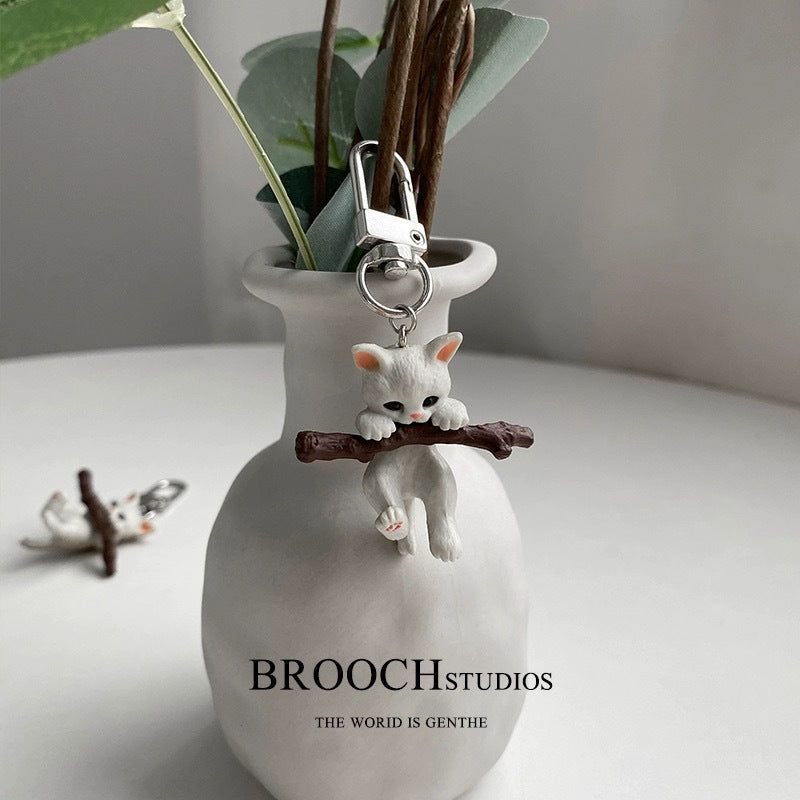 Wholesale Cartoon cute cat holding a branch keychain