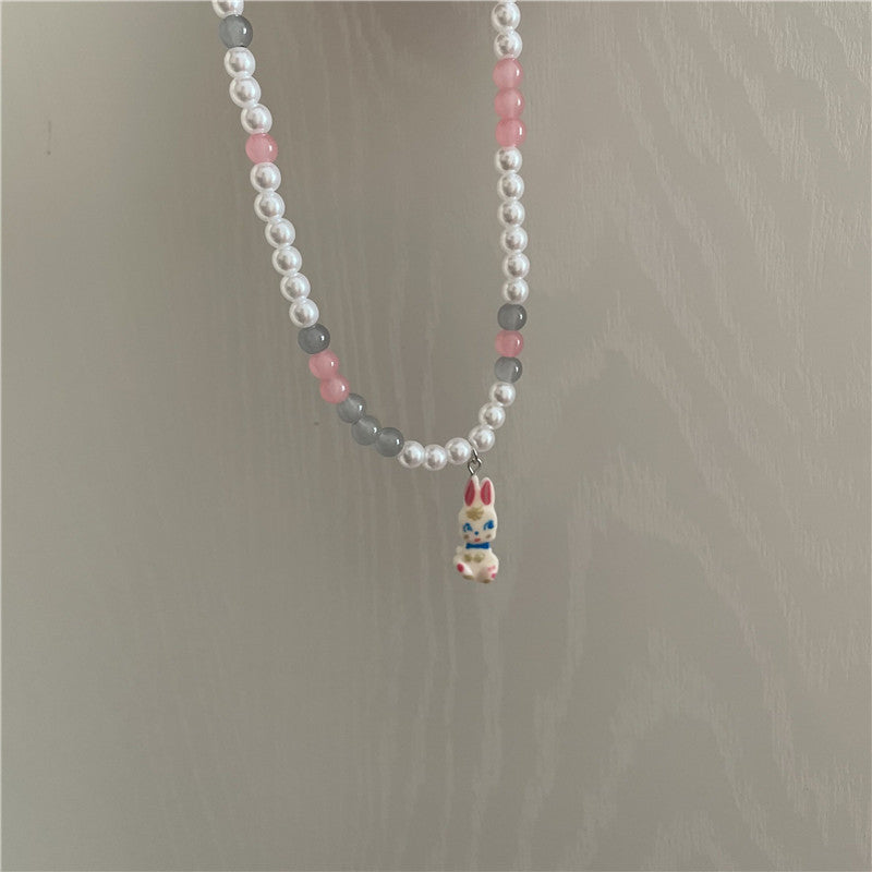 Venta al por mayor Pearl Bunny Collares De Acero De Titanio