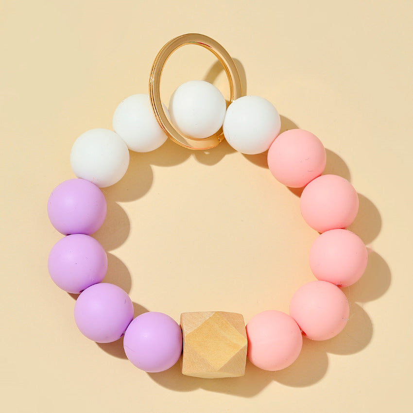 Venta al por mayor Llavero de muñeca con cuentas de silicona de color caramelo