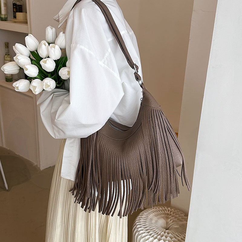 Venta al por mayor Bolso de cubo diagonal con borla de PU