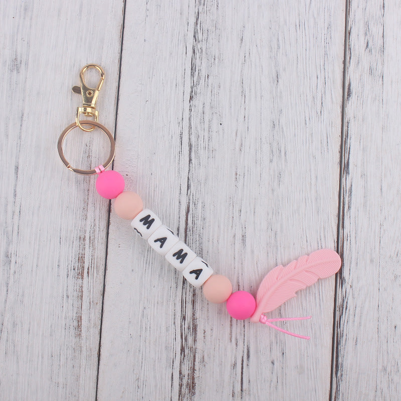 Llavero de plumas con cuentas de silicona colorida al por mayor