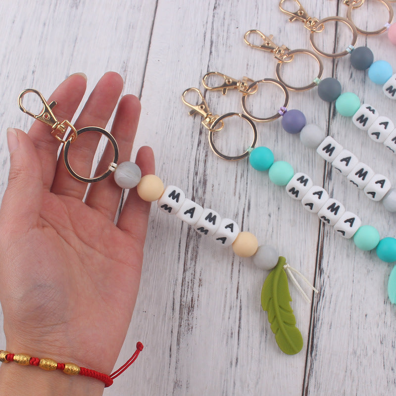 Llavero de plumas con cuentas de silicona colorida al por mayor