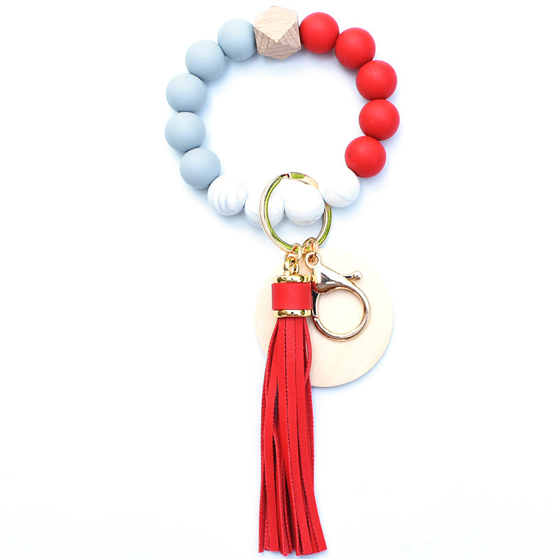 Llavero de muñeca de cuentas de madera con borla de silicona al por mayor