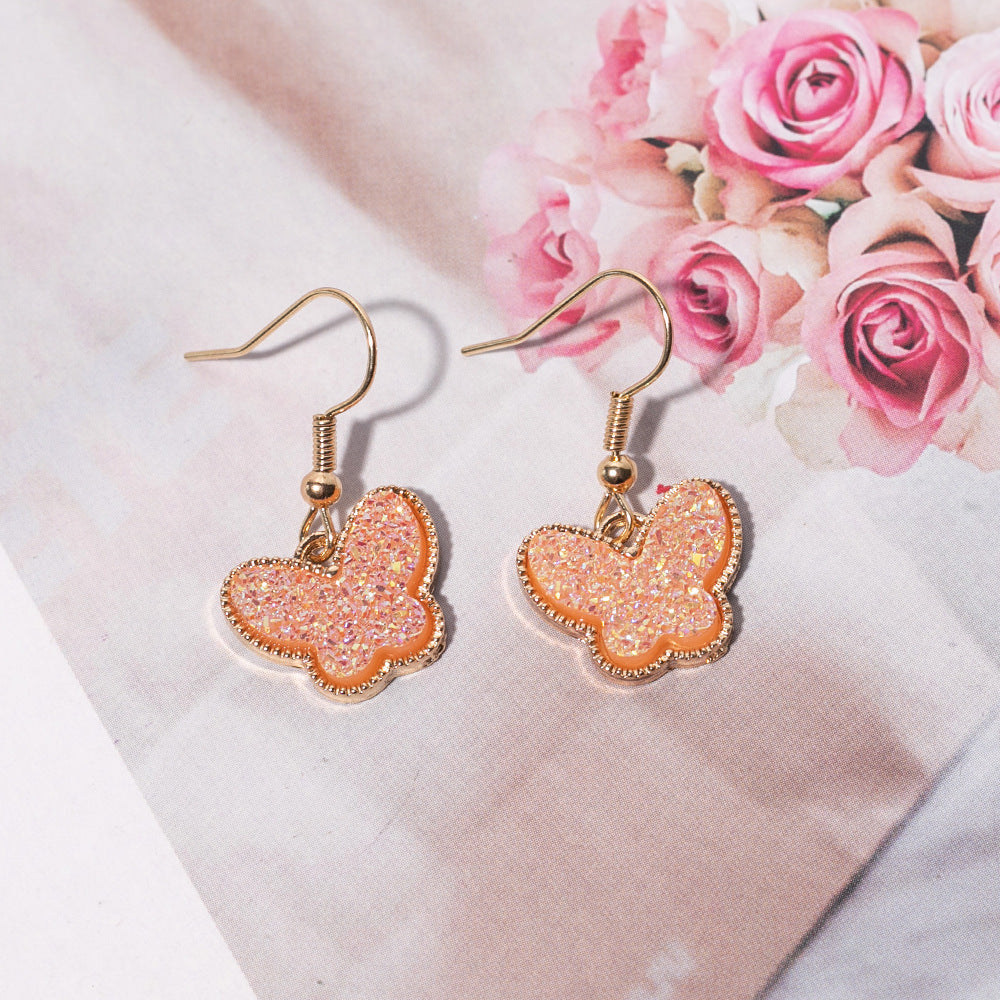Pendientes de aleación de mariposa de resina de color de joyería al por mayor