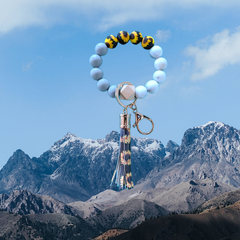 Venta al por mayor Llavero de muñeca con cuentas de silicona de girasol