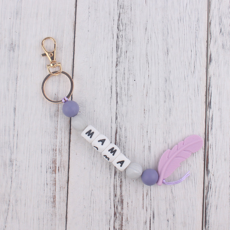 Llavero de plumas con cuentas de silicona colorida al por mayor