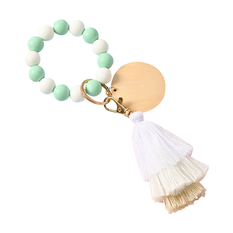 Venta al por mayor Llavero de la pulsera del grano del silicón de la borla