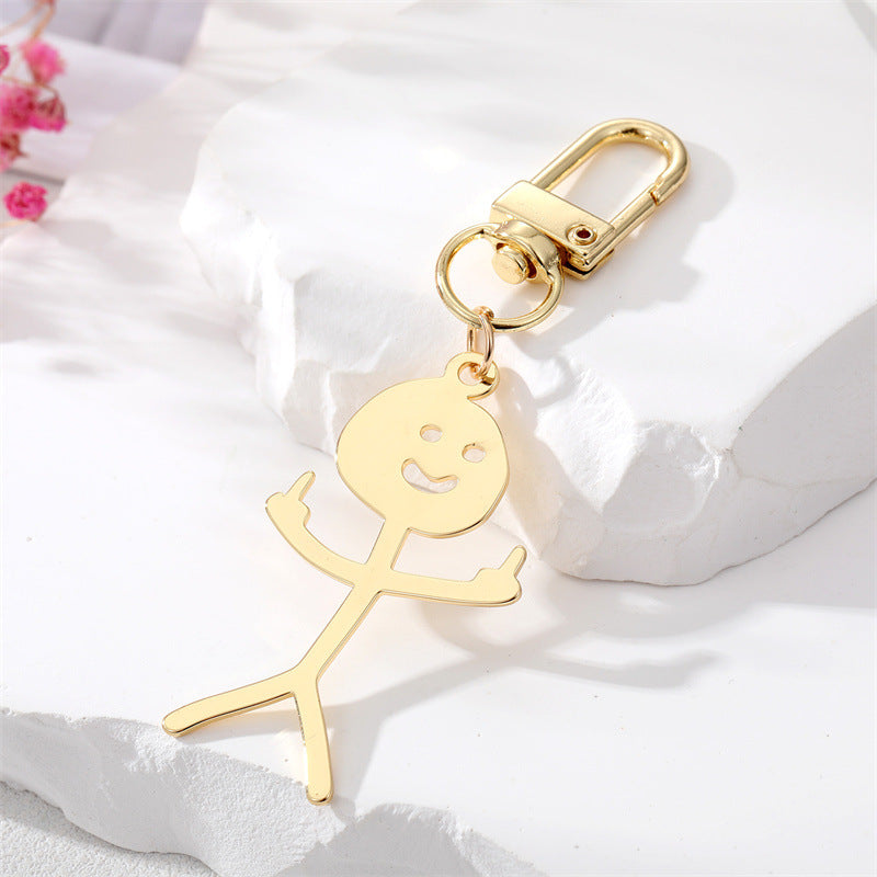 Comercio al por mayor de dibujos animados de acero inoxidable Graffiti dedo medio villano llavero