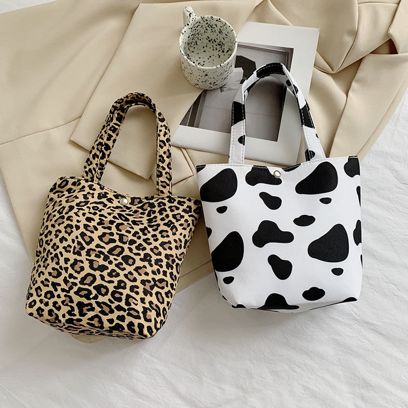 La bolsa de asas de mariposa con estampado de leopardo y estampado de vaca de poliéster al por mayor