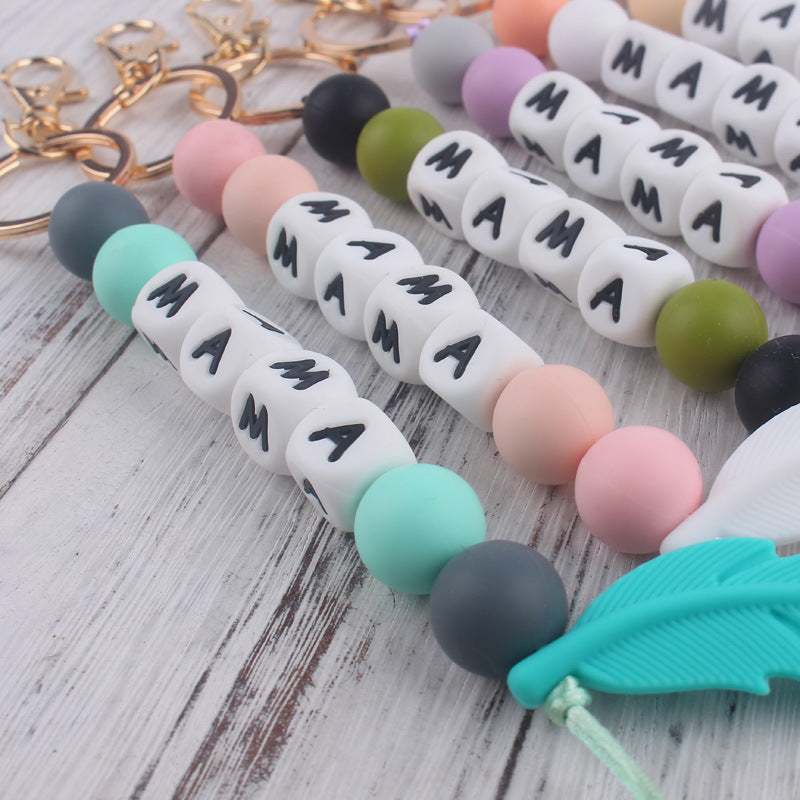 Llavero de plumas con cuentas de silicona colorida al por mayor