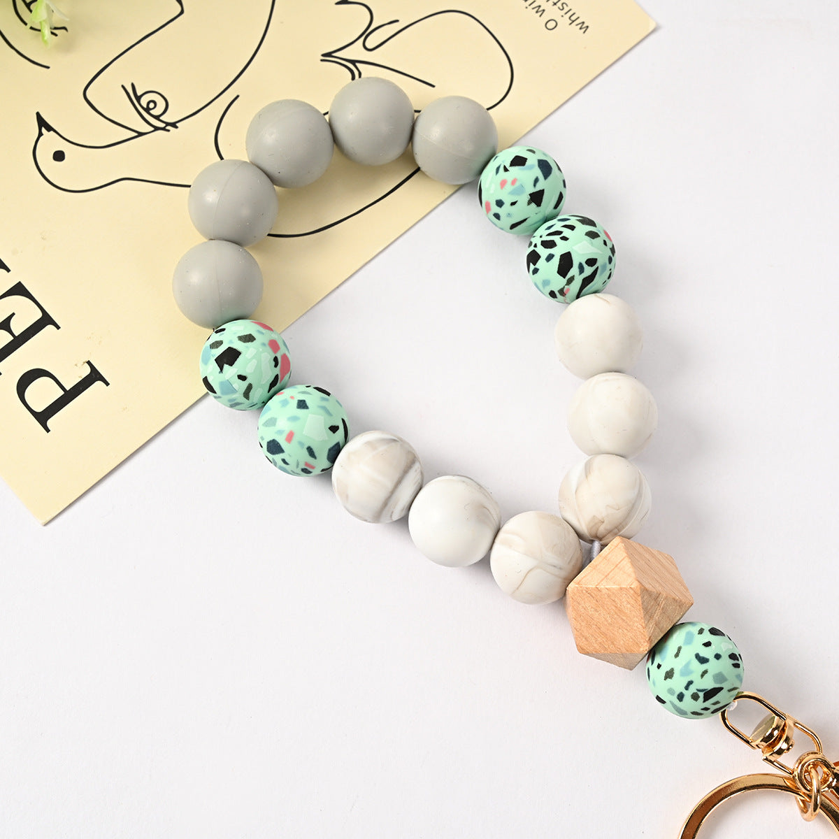 Venta al por mayor Llavero de la pulsera del grano del silicón de la borla