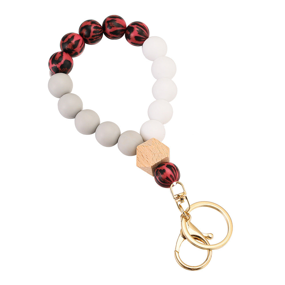 Llavero de muñeca con cuentas de madera de leopardo de leopardo.