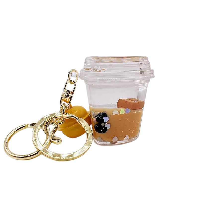 Comercio al por mayor acrílico flotando en el aceite de chocolate arenas movedizas llavero creativo
